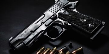 A representational image of a closeup pistol surrounded by bullets. [Photo: Courtesy]